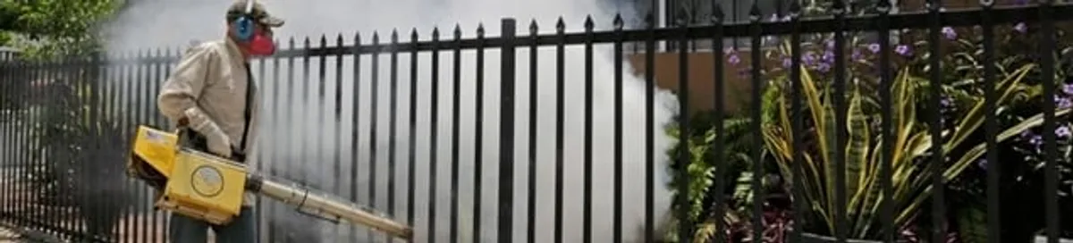 Mosquito control technician fogging a yard perimeter for mosquito reduction in Green Bay, WI